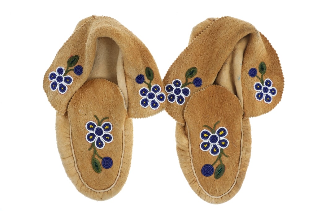 Ca. 1960's Flathead Hide Beaded Mocassins: Featured in this lot is this pair of Flathead moose hide beaded mocassins circa 1960's. The mocassins feature a wonderfully and professionally crafted moose hide construction with trade seed beaded de
