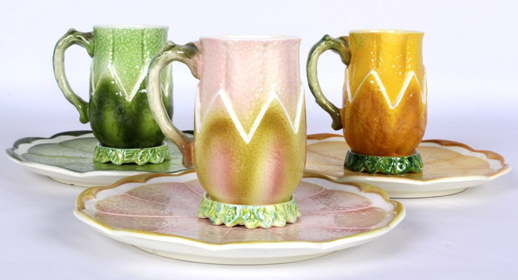 Majolica Fruit Cup and Saucer Set: These are all hand painted and features a set of 3. Each set includes a Mug with the fruit and leaf motif, a coaster in the shape of leaves, and also plates with the appearance of the sliced fruit suc