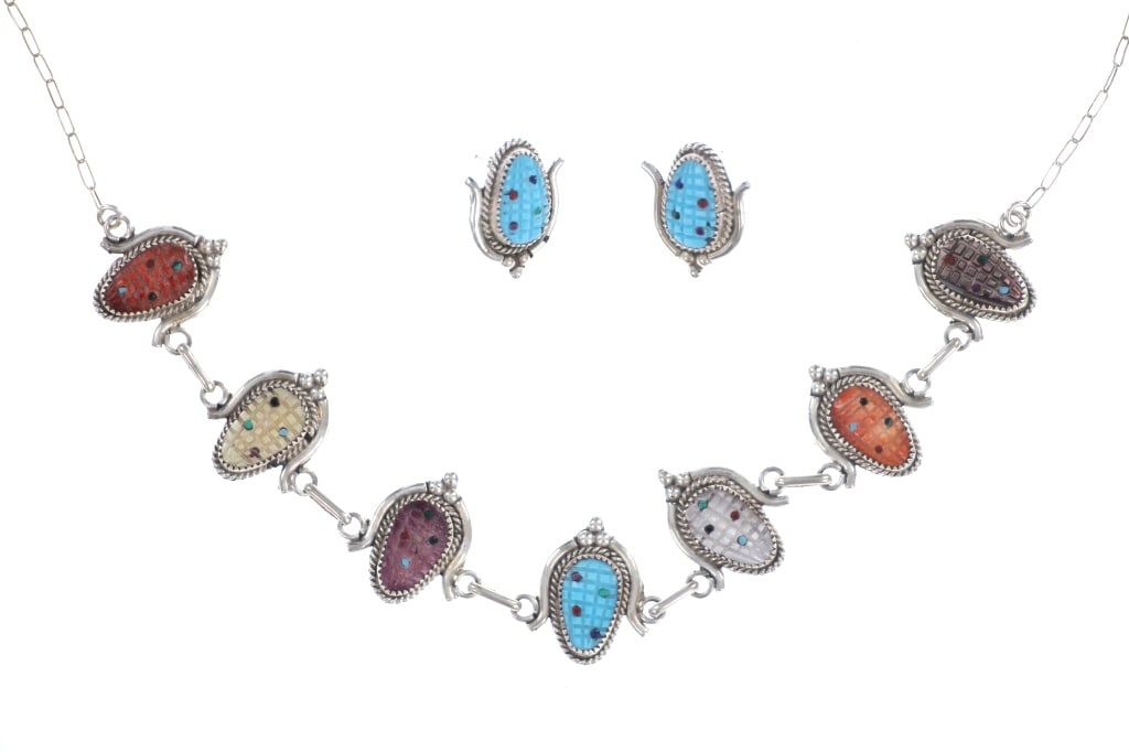 Zuni Tracy Bowekaty Sterling Turquoise Necklace: Featured in this lot is this Zuni Tracy Bowekaty Sterling Silver Gem Corn Turquoise Necklace and Earrings. The pieces feature a vibrant palette of hand-cut stones, including turquoise, coral, mother o