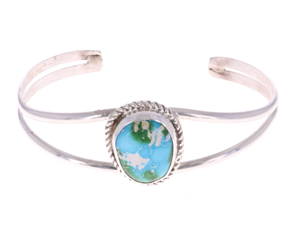 Navajo Sierra Bella Turquoise Bracelet -Tsosie: Featured in this lot is this Navajo, sterling & Sierra Bella cuff bracelet made by Navajo silversmith Herbert Tsosie. This bracelet features a sterling construction showing a split shoulder frame desi