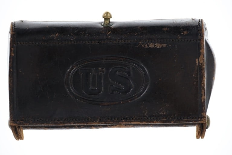 Ca. 1860's McKeever U.S. Trap Door Cartridge Case: Featured in this lot is this McKeever U.S. trap door cartridge case. The case is made from leather with a brass hinge rod and clasp. The front of the case is marked "U.S.". When open, the case will