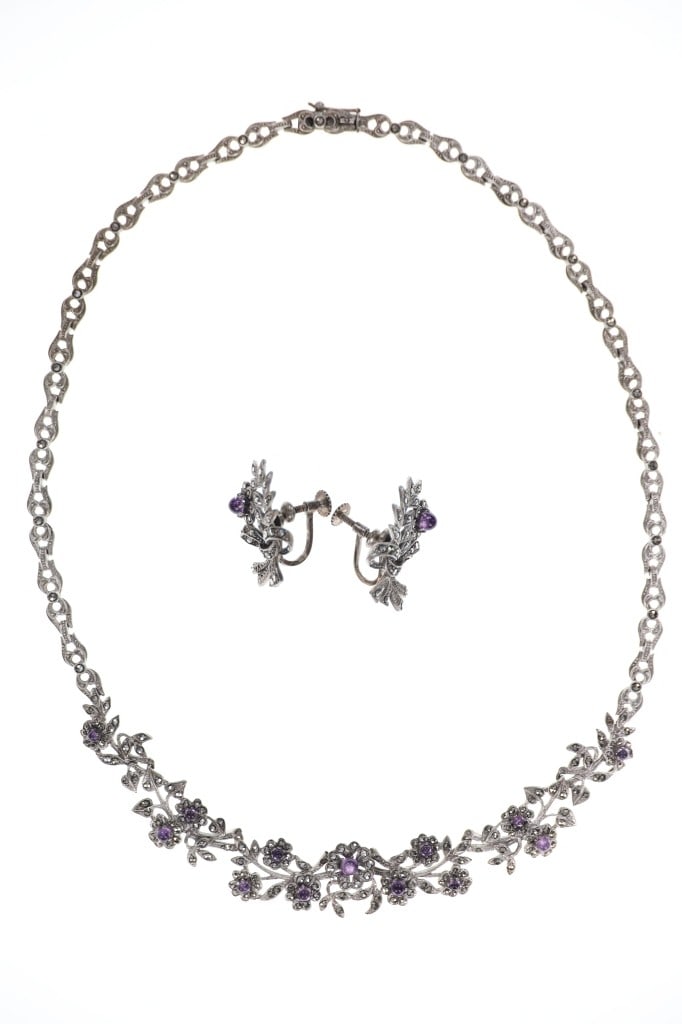 Antique Costume Silver Amethyst Jewelry Set: Featured in this lot is this antique costume silver amethyst jewelry set circa 1940's. The jewelry features a wonderfully and professionally crafted silver construction with amethyst gemstones set int