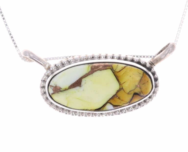 Navajo Dahlia Turquoise Necklace - Signed: Featured in this lot is this Navajo, sterling & Dahlia turquoise necklace made by Navajo silversmith Jennifer Begay. This necklace features a sterling construction with an oval shaped pendant of Dahli