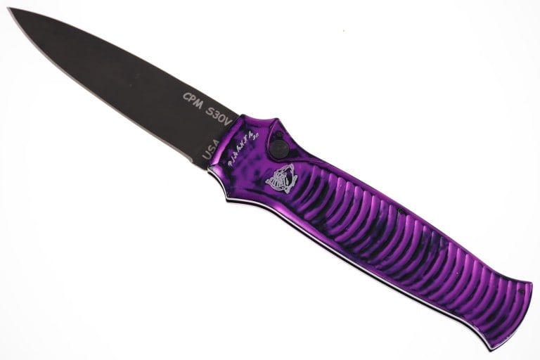 Piranha Bodyguard Automatic Stiletto Switchblade: Featured in this lot is this Piranha Bodyguard automatic switchblade knife. The Piranha Bodyguard is a contemporary spin on the classic stiletto style. It features a purple and black camo style colorw