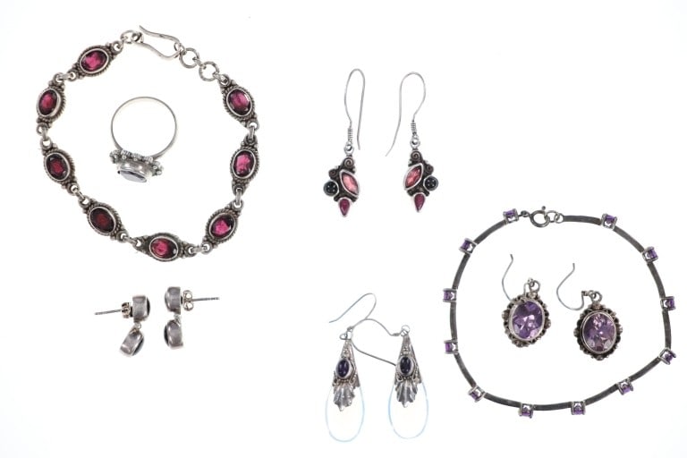 Antique Sterling Silver Amethyst Costume Jewelry: Featured in this lot is this antique sterling silver amethyst costume jewelry circa 1940's. There is one ring, four pairs of earrings, and two bracelets in this collection. The first piece of jewelry