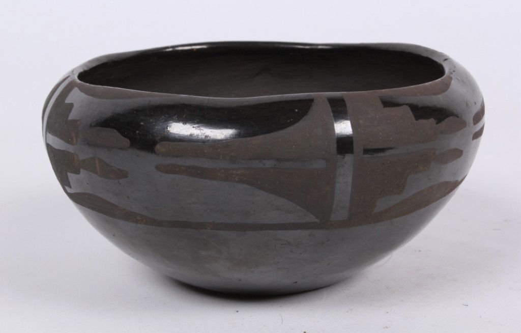 San Ildefonso Black on Black Bowl: This piece is a hand made work art done by the San Ildefonso Native Americans and features the very collectible and well made Black on Black style bowl. This shows a dark clay with a glossy black fini
