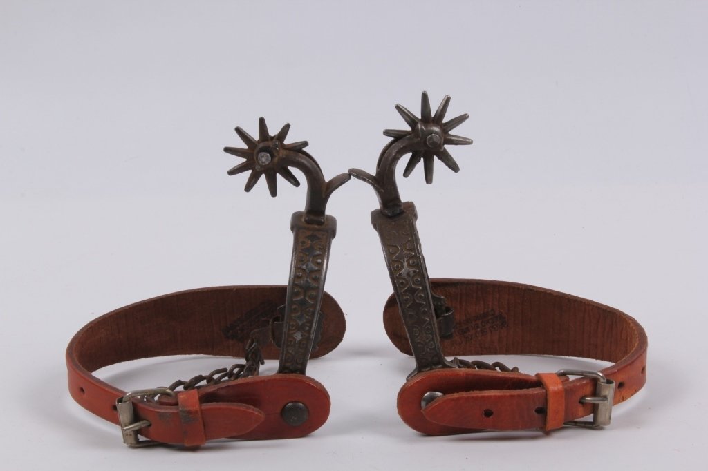 Buermann Chased Iron Spurs: These are hand made from the Oldest spur maker in America Buermann. These are from the 19th century and have the original heel chain. The spurs are made of iron and feature chased steel carved works o