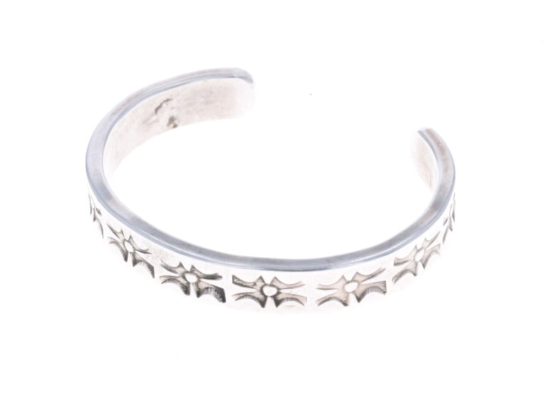 20th C. Navajo Sterling Silver Stamped Bracelet: Featured in this lot is this Navajo sterling silver stamped bracelet circa 20th century. The bracelet features a wonderfully and professionally crafted sterling silver construction that shows geometri