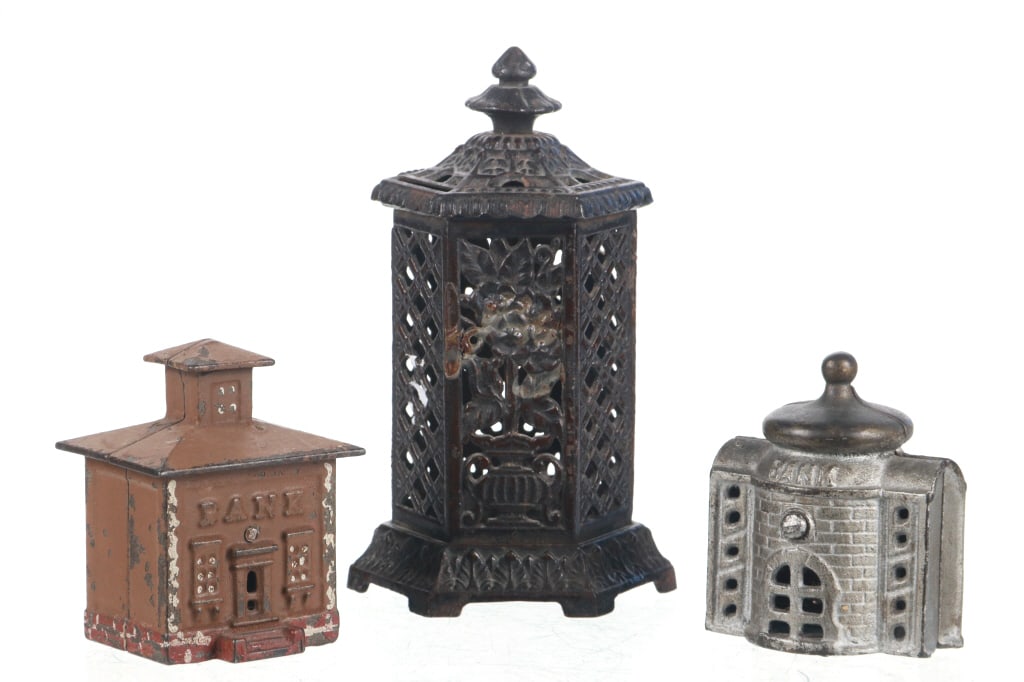 19th C. Variety Cast Iron Still Bank Coin Banks: Featured in this lot is this variety cast iron still bank coin banks circa b19th century. There are a total of three still banks in this collection. The first is the largest and shows a birdcage desig