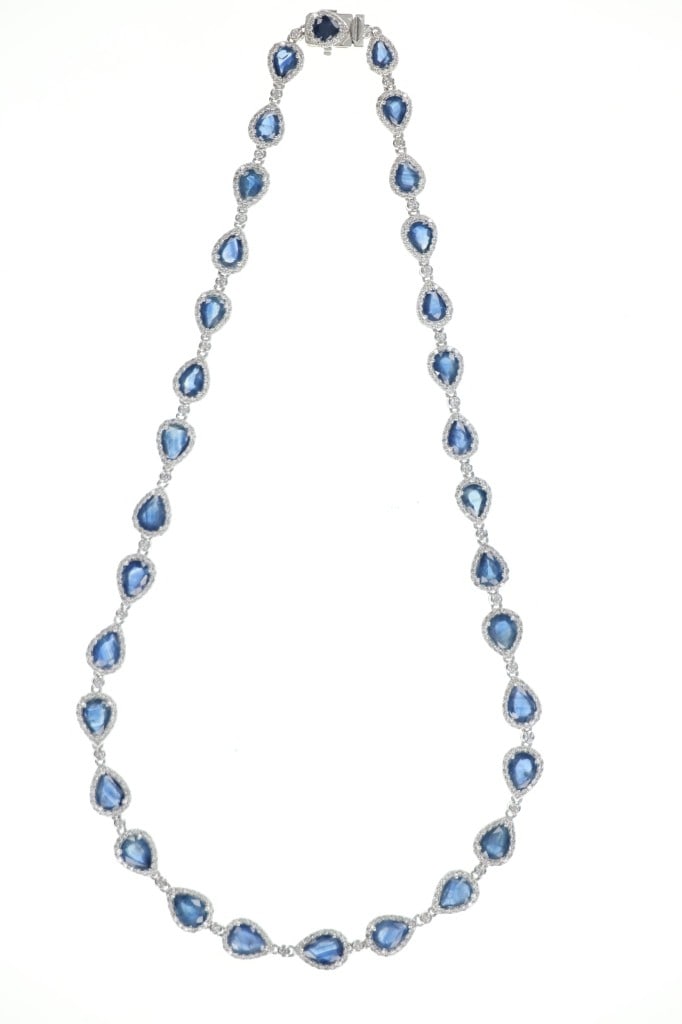 Designer Fine 29.88 ct. Blue Sapphire VS1 Necklace: The lot features an Oscar Friedman designer platinum necklace set with 29.88 carats of natural Blue Sapphires with VS1 natural diamonds and paperwork. The sapphires total 32 pear brilliant cut stones 