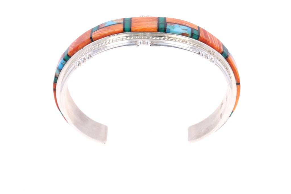 Navajo Joan Douglas Multistone Inlay Bracelet: Featured in this lot is this sterling silver and multistone inlay bracelet from Navajo artist Joan Douglas. The bracelet features a wonderfully and professionally crafted sterling silver and multiston