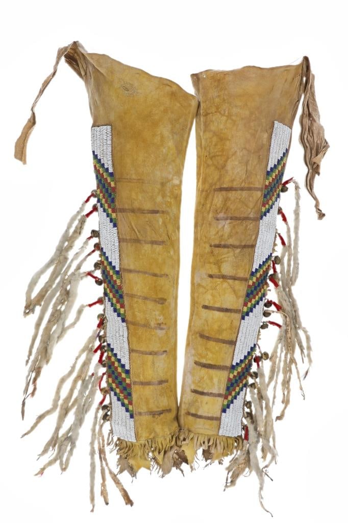 ca.1870 Blackfeet Beaded Hide Leggings ex-Winchell: This is an exceptional and historic set of circa 1870-1880 Blackfeet Beaded Indian Buffalo Hide men?s warrior leggings from the ex-collection of Terry Winchell at Fighting Bear Antiques; collected fro