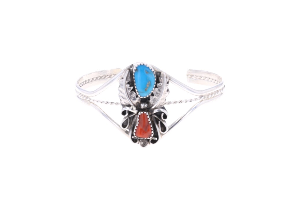 Navajo Harry B. Yazzie Sterling Turquoise Bracelet: Featured in this lot is this sterling silver turquoise and red branch coral bracelet from Navajo artist Harry B. Yazzie. The bracelet features a wonderfully and professionally crafted sterling silver,
