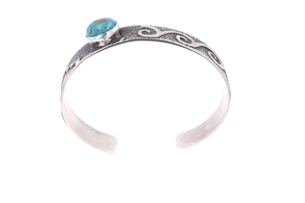Navajo Randy Begay Jr Sterling Turquoise Bracelet: Featured in this lot is this sterling silver and turquoise bracelet from Navajo artist Randy Begay Jr. The bracelet features a wonderfully and professionally crafted sterling silver and turquoise cons