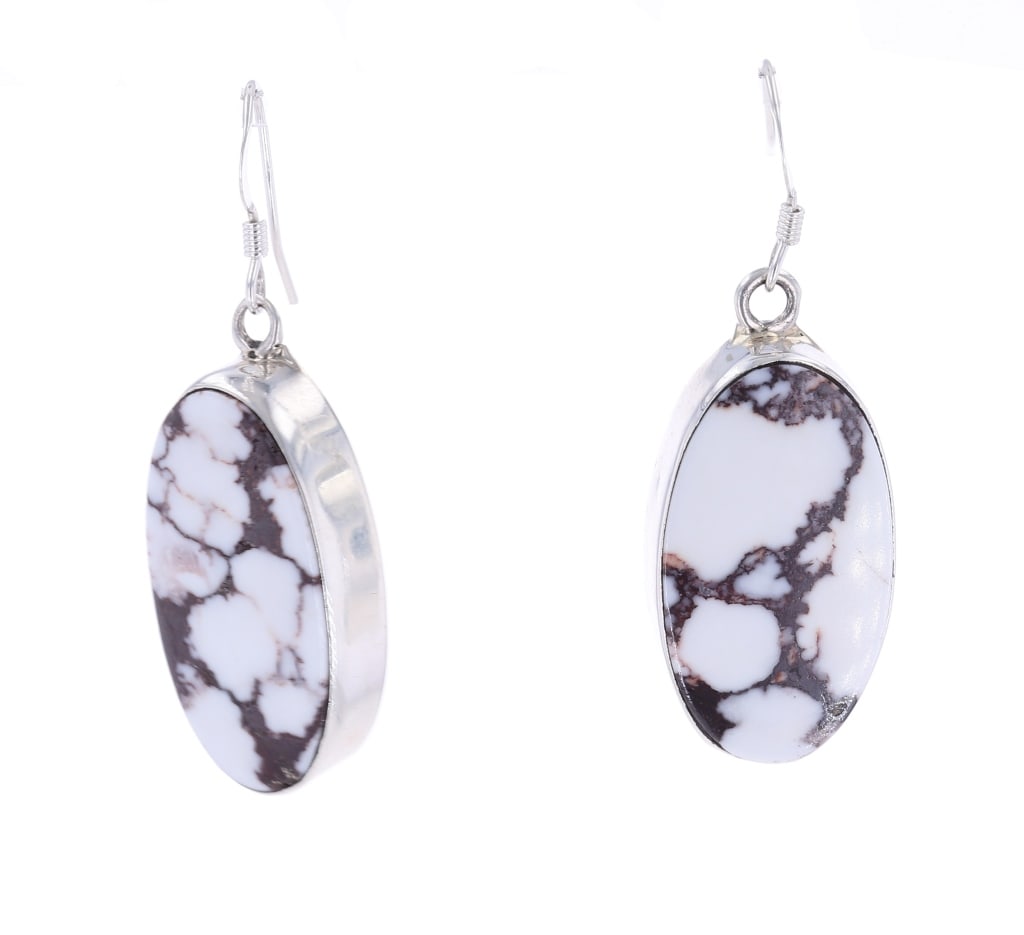 Navajo A. Johnson White Buffalo Turquoise Earrings: Featured in this lot is this sterling silver White Buffalo Turquoise earrings from Navajo artist A. Johnson. The pair of earrings is wonderfully and professionally crafted sterling silver and White Bu