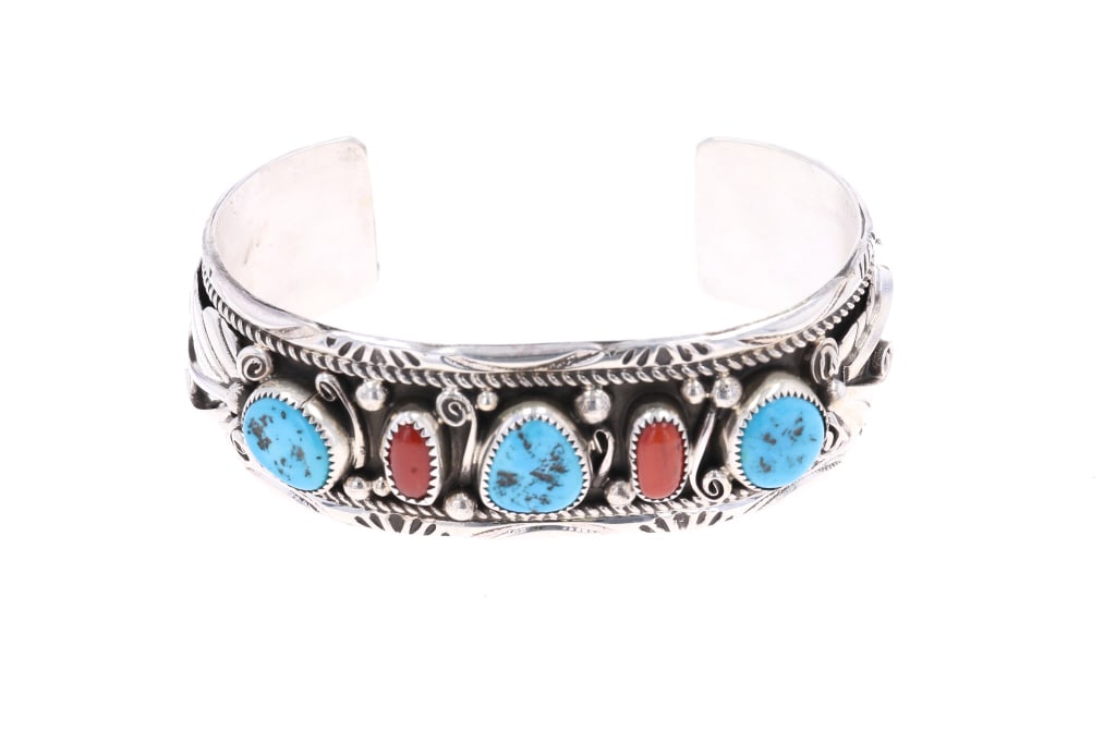 Navajo Tsosie Sterling Silver Turquoise Bracelet: Featured in this lot is this sterling silver turquoise bracelet from Navajo artist Herbert Tsosie. The bracelet features a wonderfully and professionally crafted sterling silver, turquoise, and red br