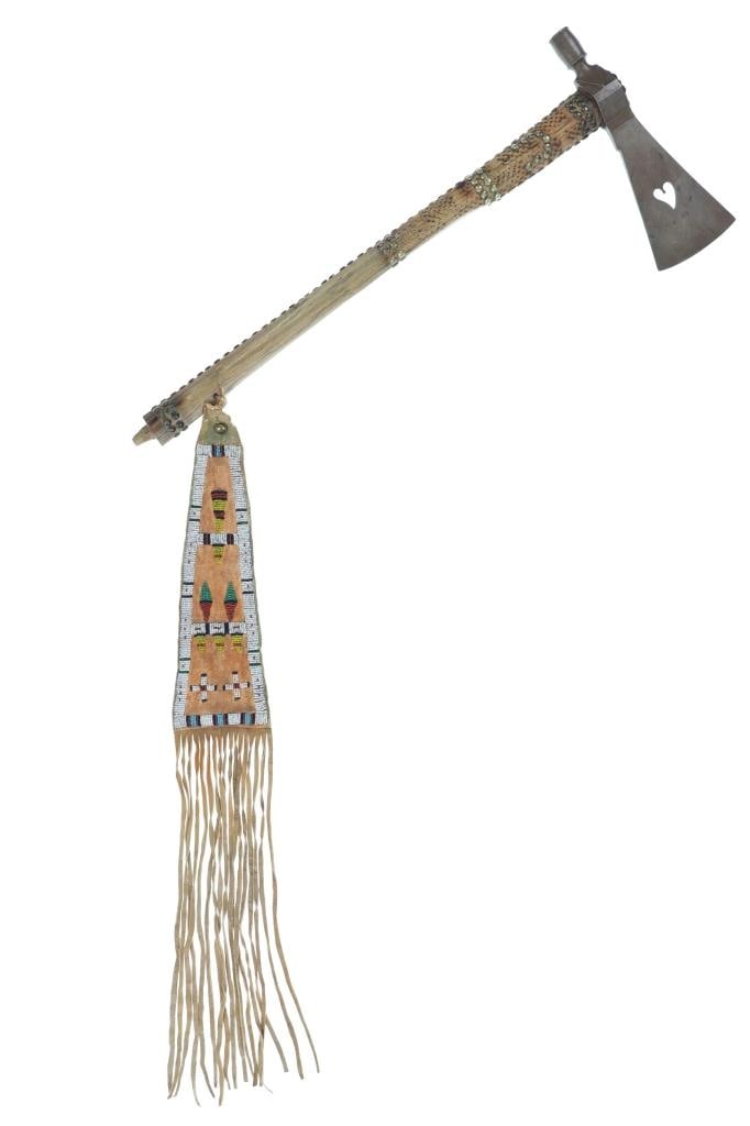 c. 1870 Cheyenne Tomahawk w/ Beaded Drop ex-Museum: The lot features a terrific and authentic circa 1870 pipe tomahawk with beaded drop from the Southern Cheyenne from an ex-Museum East Coast collection. This piece was named the ?Blonde Beauty? by the 