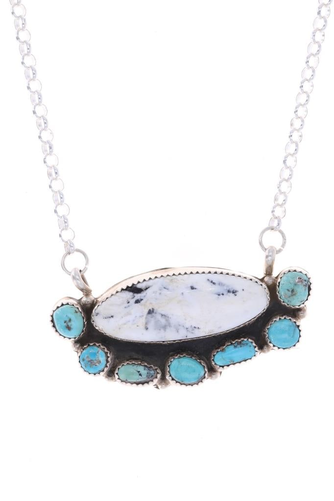 Navajo Sam Sterling Silver White Buffalo Necklace: Featured in this lot is this sterling silver white buffalo turquoise necklace from Navajo artist R. Sam. The necklace features a wonderfully and professionally crafted sterling silver and turquoise co