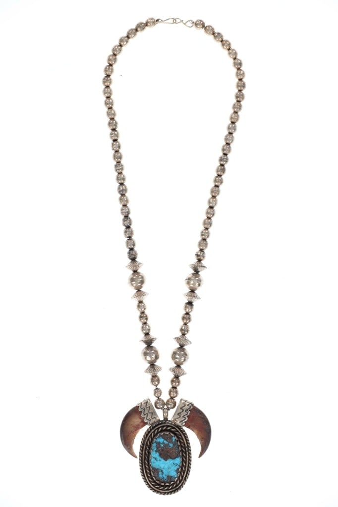 Navajo Sterling Silver Pearl & Bear Claw Necklace: Featured in this lot is this Navajo sterling silver pearl and bear claw turquoise necklace circa 1950's. The necklace features a wonderfully and professionally crafted sterling silver construction tha