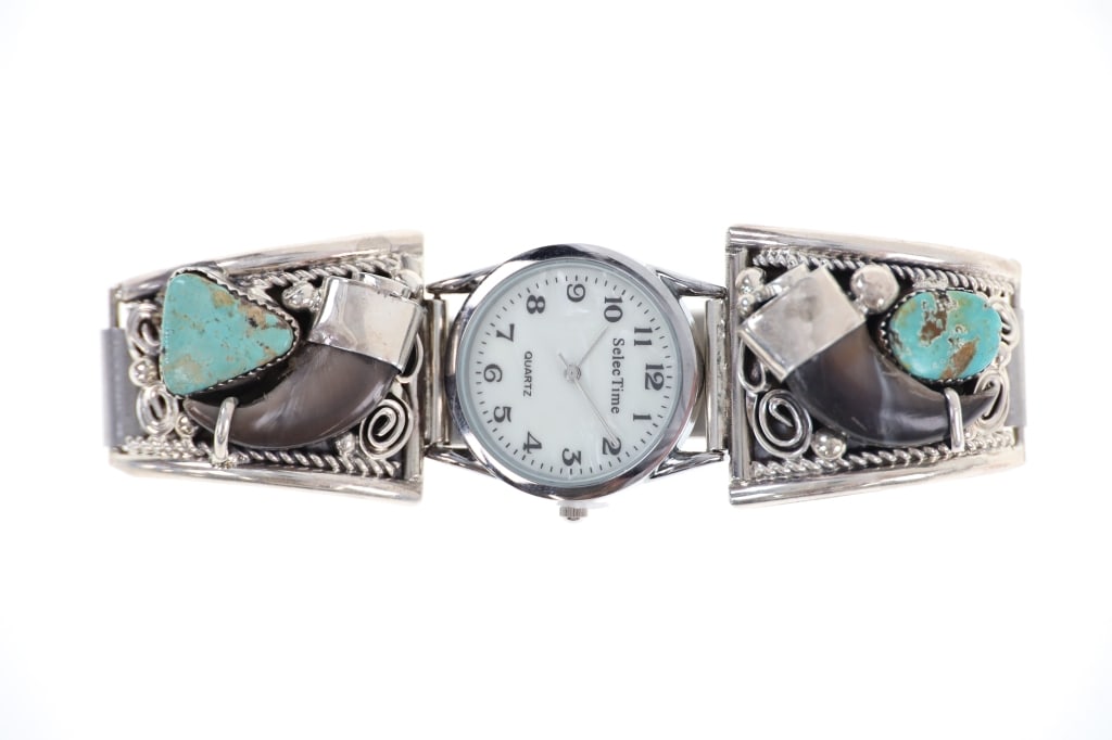 Navajo M. Thomas Jr Bear Claw Turquoise Watchband: Featured in this lot is this sterling silver bear claw and turquoise watch band by Navajo artist Mike Thomas Jr. The watchband features a wonderfully and professionally crafted sterling silver, bear c