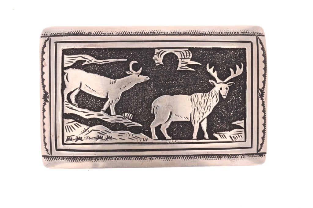 Navajo Tommy Singer Sterling Silver Elk Buckle: Featured in this lot is this Navajo Din? Tommy and Rose Singer Sterling Silver Elk Buckle. The buckle features a wonderfully and professionally crafted sterling silver construction that shows a tooled