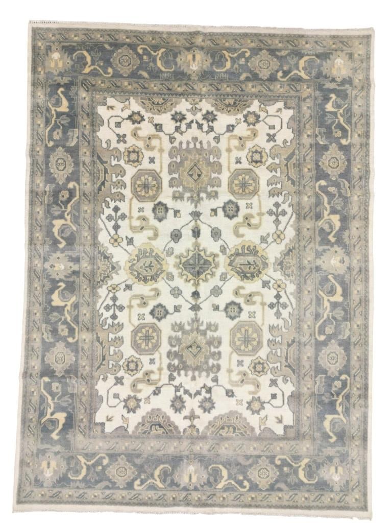 ca. 1930's Oushak Persian Hand Knotted Large Rug: Featured in this lot is this lot is this Oushak Persian hand knotted Ivory Beige camel border rug circa 1930's. The rug features a wonderfully and professionally crafted wool construction that shows s