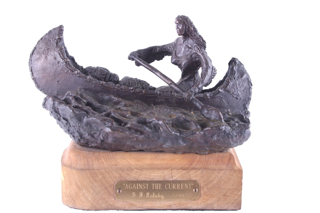 J. F. Policky (b.1955) Native Canoe Bronze: For your consideration is an Original J. F. Policky Bronze "Against The Current", Limited Edition. An Indian woman is seen sitting in a canoe and paddling through the bronze waters. She is wearing a f