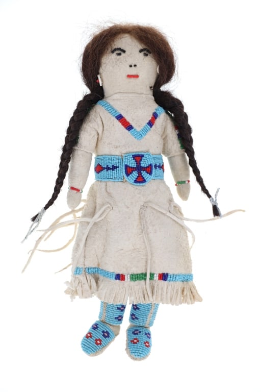 ca. 1940 Blackfeet Beaded Hide Indian Doll: The lot features a circa 1940-1950's Blackfeet beaded Indian hide doll. The doll is comprised of Indian tanned hides with glass trade seed beads and real braided human hair. The piece shows fully bead