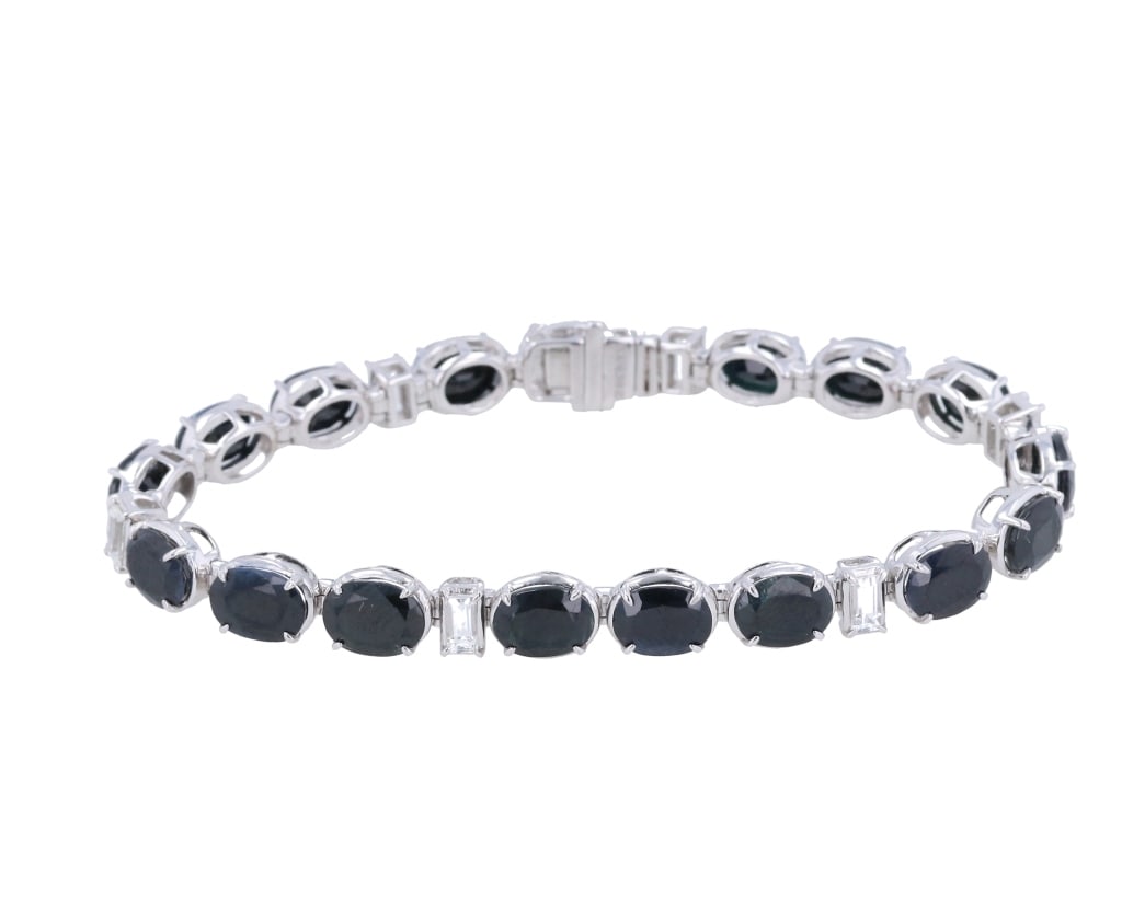 Beautiful Natural Sapphire Tennis Bracelet: Featured in this lot is this Stunning Natural Sapphire Corundum Tennis Bracelet in sterling silver. The necklace features a wonderfully and professionally crafted sterling silver (.925) with oval bril