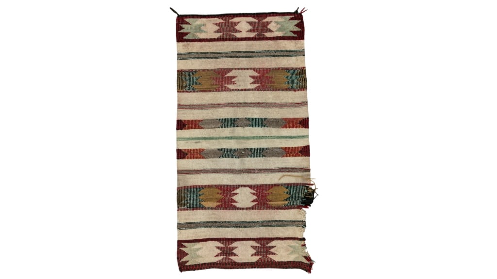 Navajo Saddle Blanket Hand Woven Rug c. 1930's: Featured in this lot is this Navajo saddle blanket hand woven rug circa 1930's. The rug features a wonderfully and professionally crafted wool construction that shows a off white field with bands of f