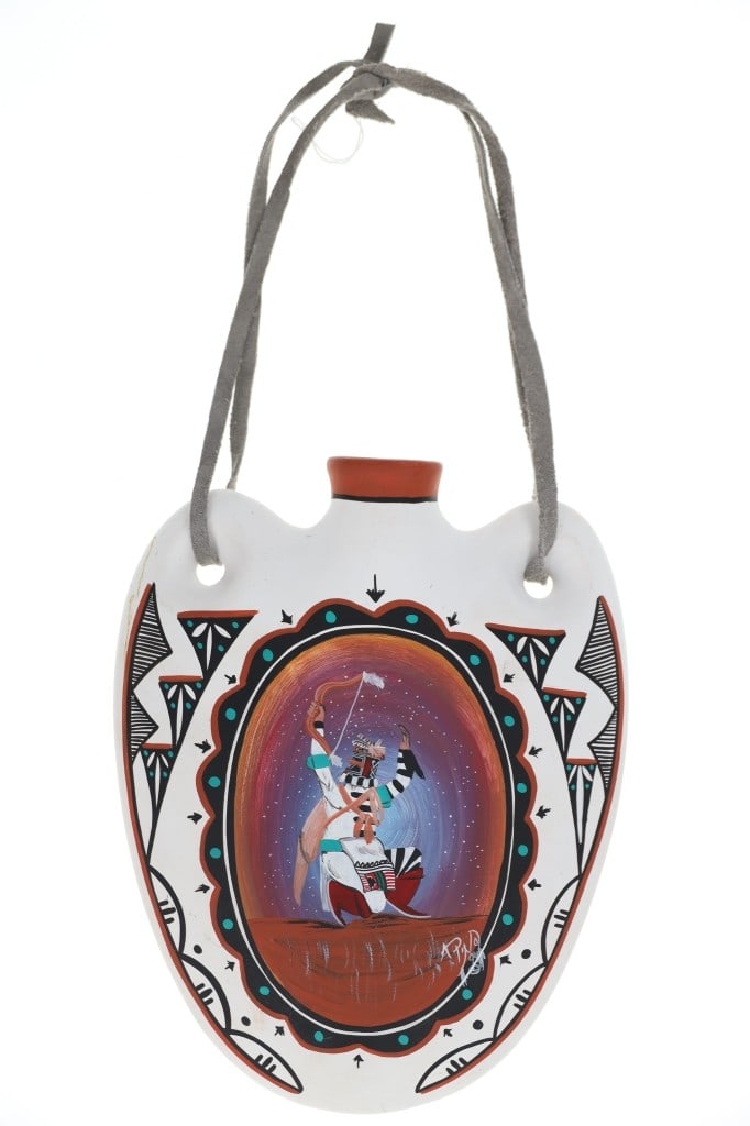 Acoma Pueblo Koshari Clown Polychrome Canteen: Featured in this lot is this Acoma Pueblo Koshari Clown polychrome canteen by A. Pino out of Laguna, New Mexico. The canteen features a wonderfully and professionally crafted ceramic construction that