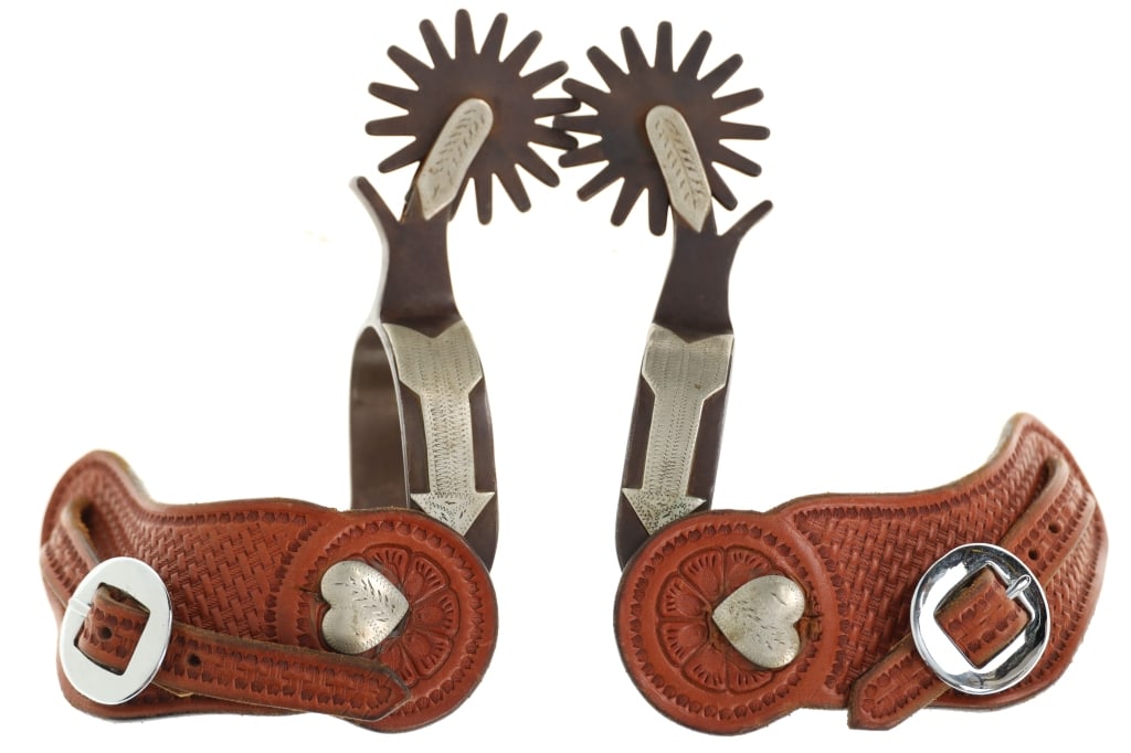 Gene Rogers #13 Western Silver Mounted Heart Spurs: Featured in this lot are Gene Rogers #13 Western Silver Mounted Heart Spurs. The spurs feature a wonderfully and professionally crafted nickel and silver mounted construction that shows a sixteen poin
