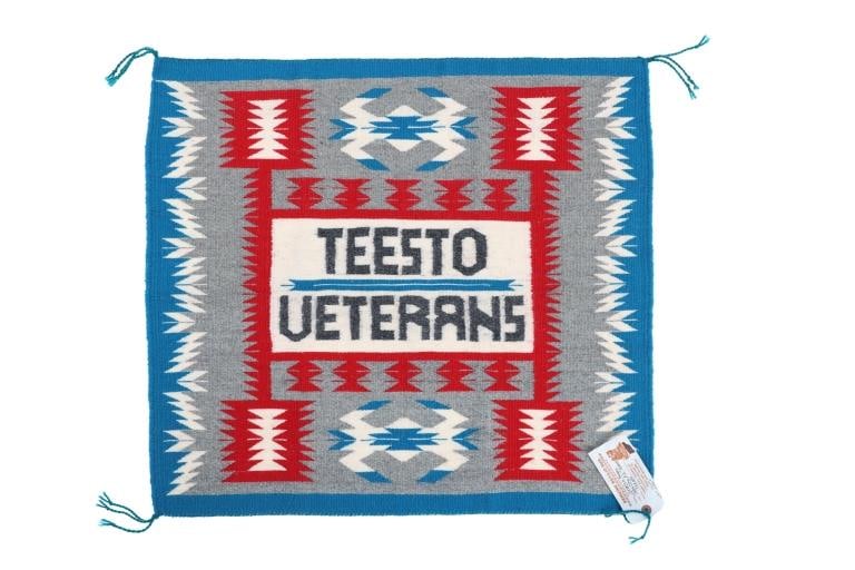 Navajo V. Begay Teesto Veterans Eye Dazzler Rug: Featured in this lot is this Navajo Eye Dazzler rug for Teesto Veterans by Navajo weaver Veronica Begay. The rug features a wonderfully and professionally crafted hand woven wool construction that sho