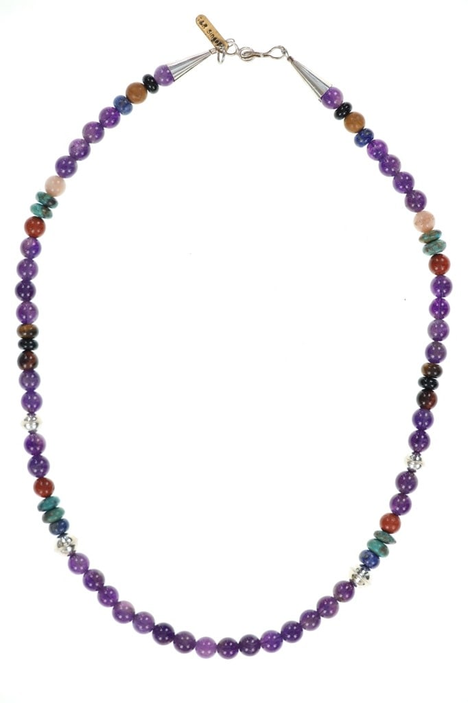 Navajo T & R Singer Sterling Amethyst Necklace: Featured in this lot is this sterling silver amethyst necklace from Navajo artists Tommy and Rose Singer. The necklace features a wonderfully and professionally crafted sterling silver aglets with the