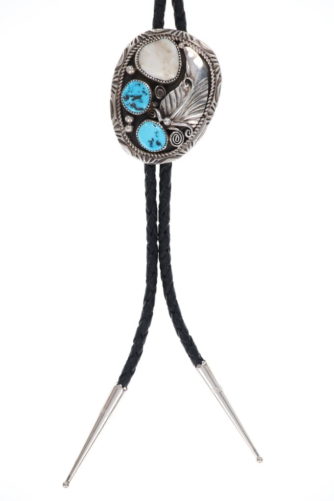 Navajo H. Tsosie Sterling Silver Turquoise Bolo: Featured in this lot is this sterling silver turquoise bolo tie from Navajo artist Herbert Tsosie. The bolo tie features a wonderfully and professionally crafted sterling silver, White Buffalo Turquoi