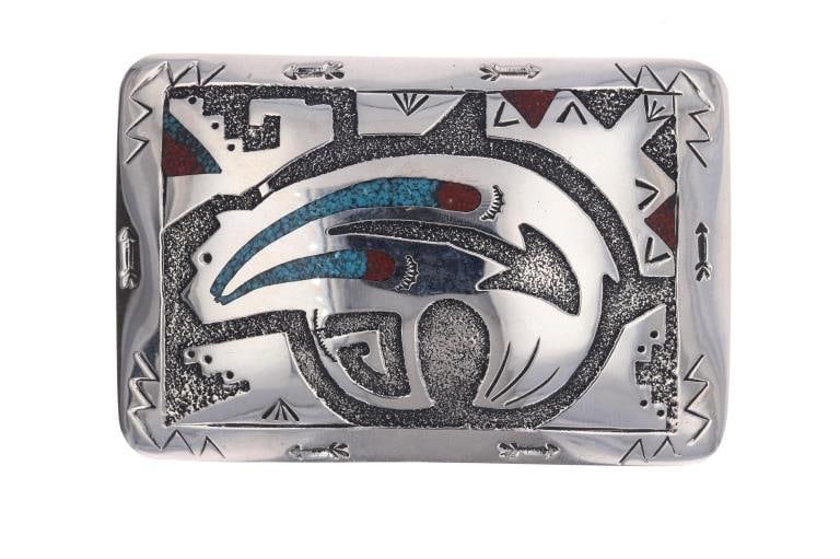 Navajo Ray Begay Nickel Silver Bear Motif Buckle: Featured in this lot is this nickel silver chipped turquoise and red branch coral bear motif buckle from Navajo artist Ray Begay. The buckle features a wonderfully and professionally crafted nickel si