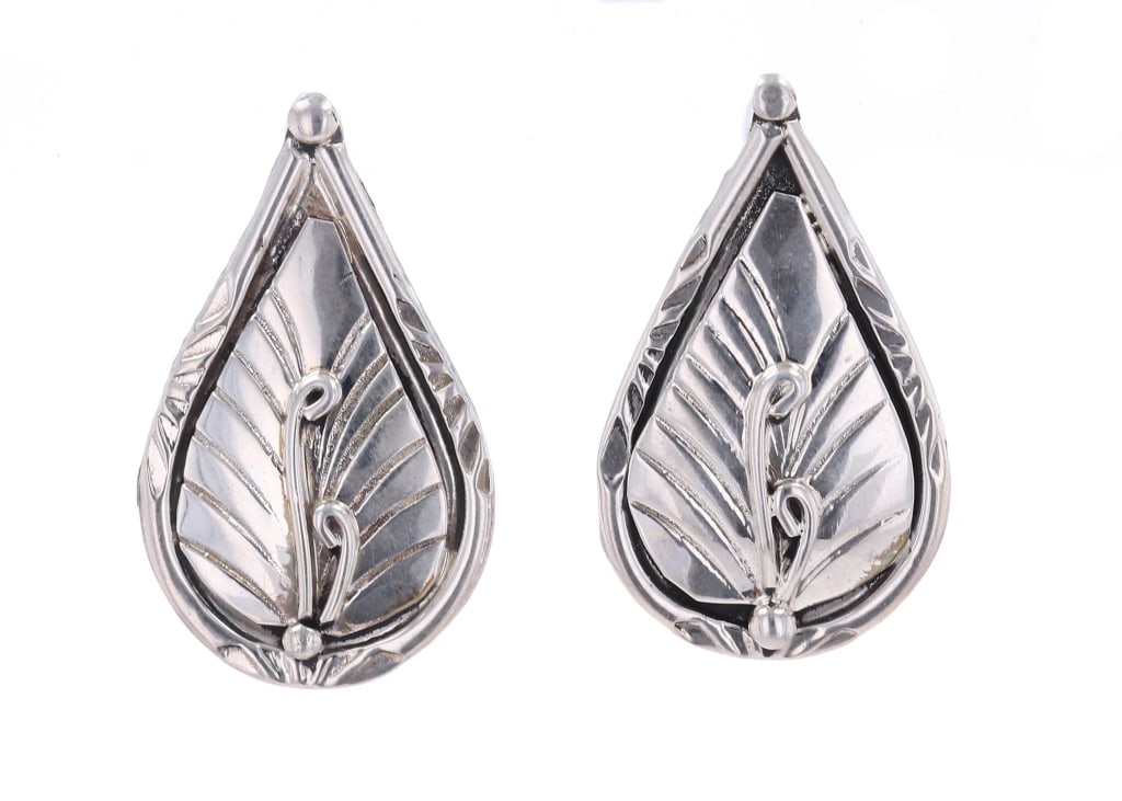 Navajo Herbert Tsosie Sterling Silver Earrings: Featured in this lot is this sterling silver earrings from Navajo artist Herbert Tsosie. The earrings feature a wonderfully and professionally crafted sterling silver construction that shows a tear