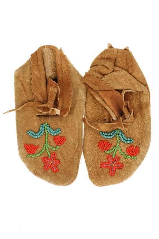 Plateau Indians Hide Floral Beaded Child Mocassins: Featured in this lot is this Plateau Indians hide and floral beaded child mocassins circa 1940's. The mocassins feature a wonderfully and professionally crafted Indian tanned deer hide construction th