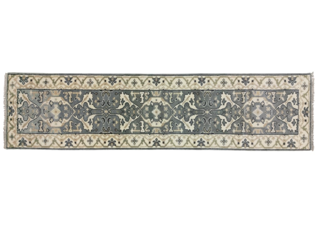 Vintage Persian Oushak Wool Runner Rug: Featured in this this lot is this hand knotted Persian Oushak wool runner rug. The rug features geometric floral patterns, light colors, and a tight weave. The Oushak rug is a style of Persian rug mad