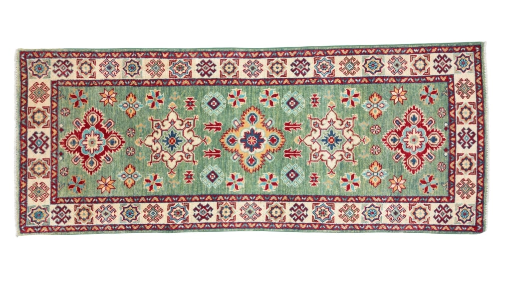 1930's Kazak Persian Hand Knotted Wool Runner Rug: Featured in this lot is this Kazak Persian hand knotted wool runner rug circa 1930's. The rug displays a fine detailed design, bright colors, and a tight weave. Kazak style rugs are similar in design 