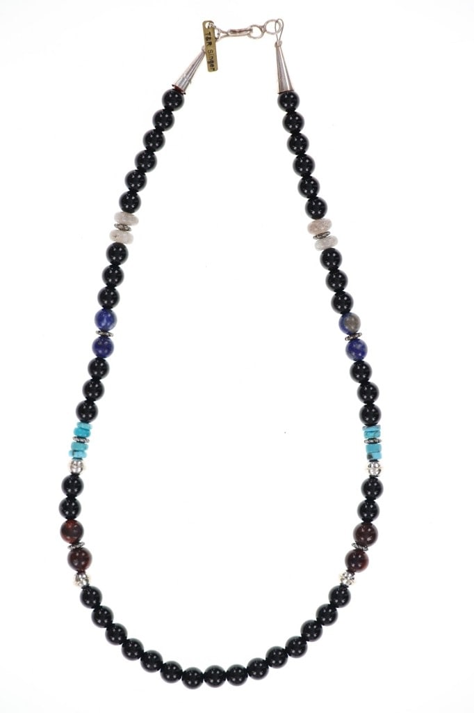 Navajo T & R Singer Sterling Onyx Necklace: Featured in this lot is this sterling silver onyx necklace from Navajo artists Tommy and Rose Singer. The necklace features a wonderfully and professionally crafted sterling silver aglets with the maj