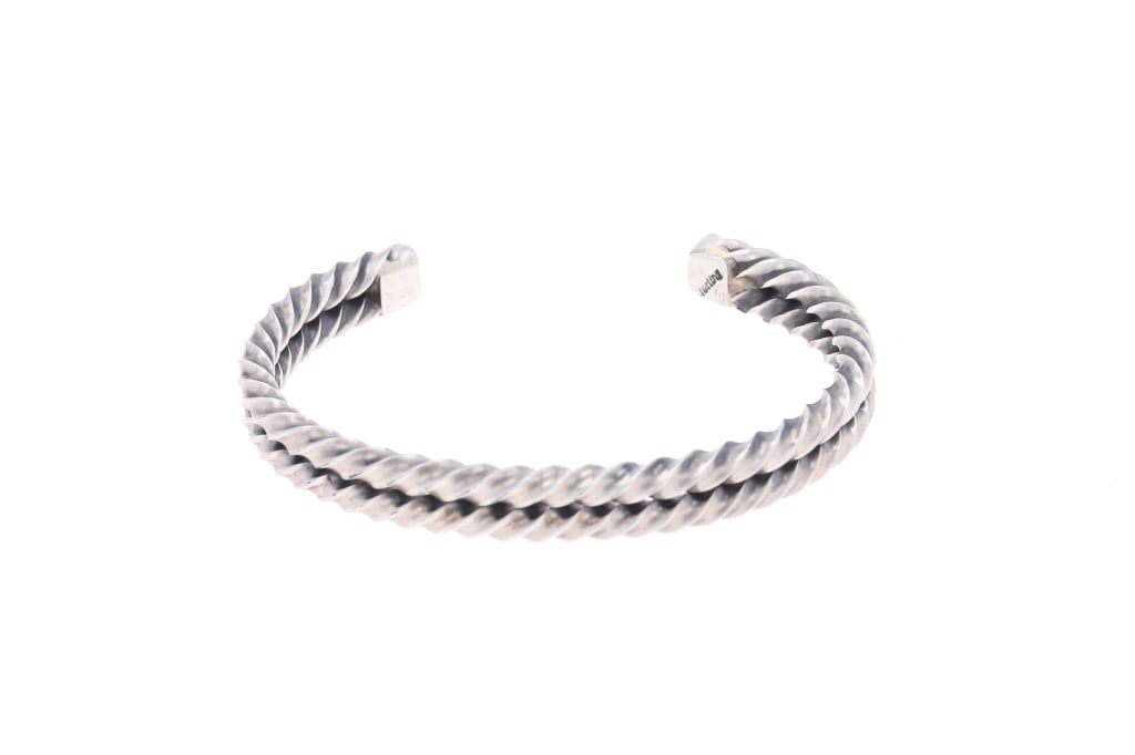Navajo Sterling Silver Twisted Rope Bracelet: Featured in this lot is this Navajo sterling silver twisted rope bracelet. The bracelet features a wonderfully and professionally crafted sterling silver construction that shows a double bar twisted r