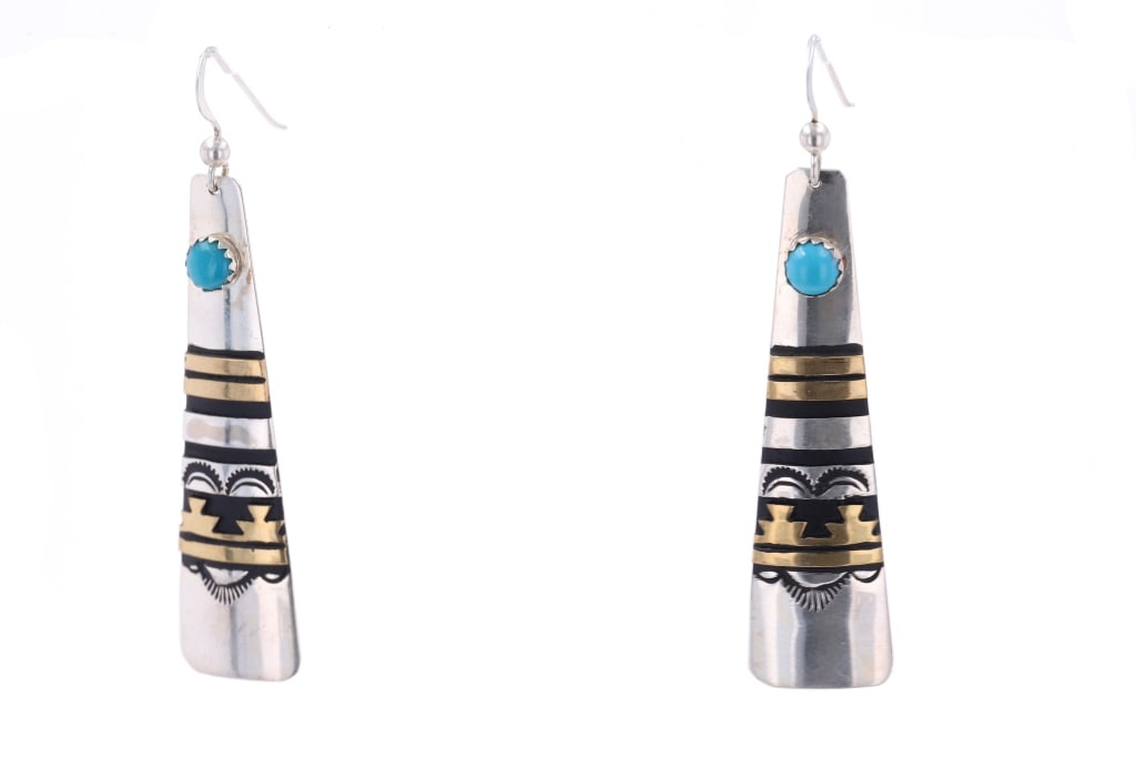 Navajo T&R Singer Sterling Silver 12k GF Earrings: Featured in this lot is this sterling silver 12k GF earrings from Navajo artist Tommy and Rose Singer. The earrings feature a wonderfully and professionally crafted sterling silver and 12k GF construc