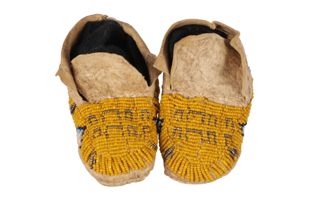 19th-Cent. Cheyenne Beaded Buffalo Hide Moccasins: The lot features a fantastic set of 19th-century Cheyenne Greasy Yellow Buffalo Track beaded buffalo hide child's moccasins from the ex-Cowans / Hindman auctions and ex-private Montana collection. The