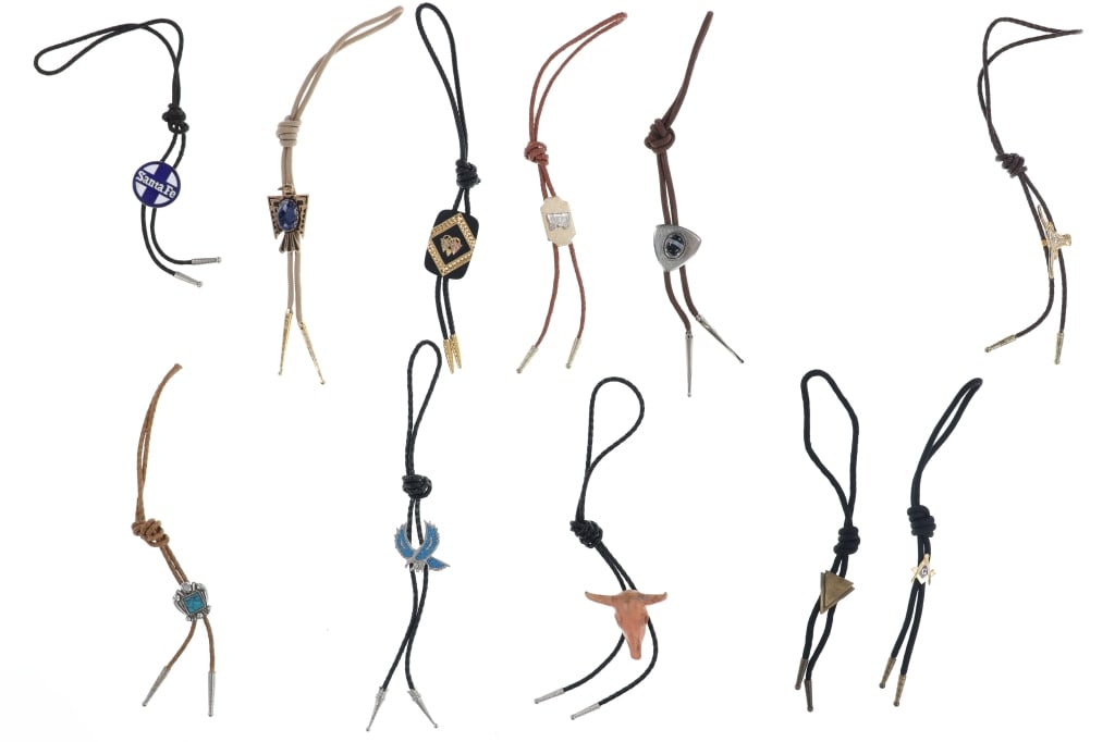 Vintage Bolo Tie Collection (11), circa 1960s: Included in this lot is a Vintage Bolo Tie Collection (11), circa 1960s. These bolos feature traditional Western-theme such as the Conestoga wagon, Arrow heads, Black Hills Gold grape leaves, Santa Fe