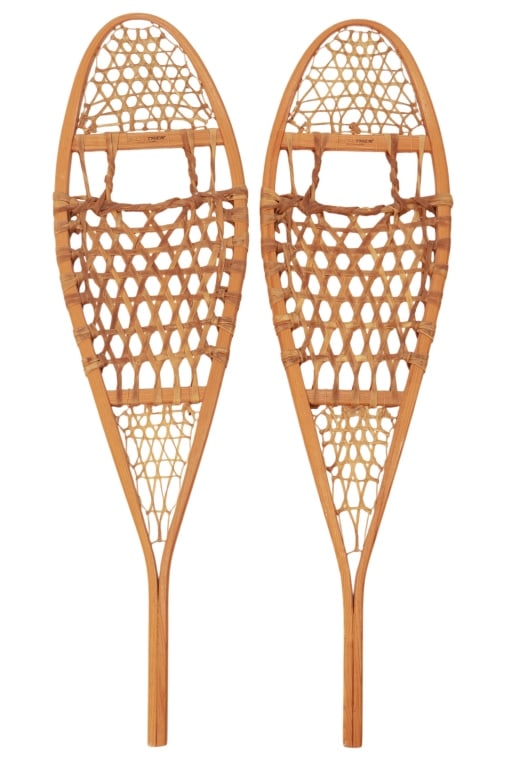Antique Canadian Wooden & Rawhide Snow Shoes: Featured in this lot is this Antique Snowtrek Snowshoes. The pair has rawhide webbing; they are marked "Made in Canada" and Snowtrek. The pair makes a excellent piece for any cabin decor. The webbing 