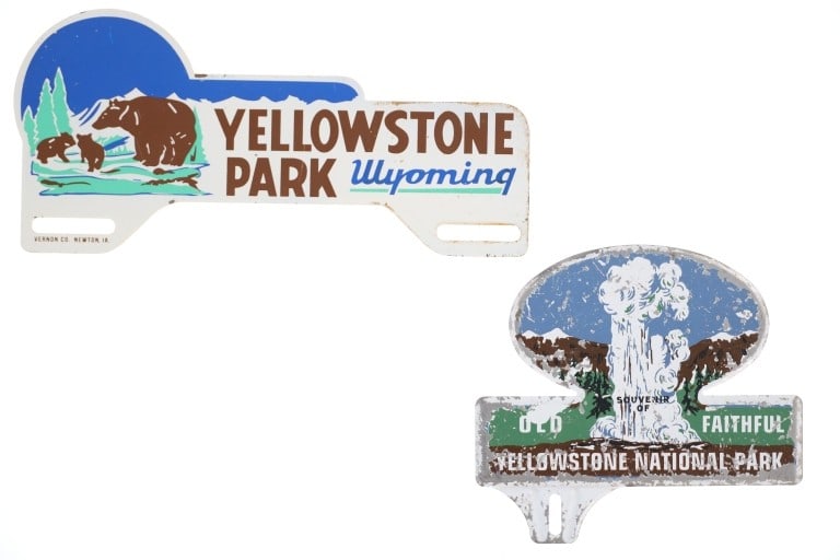 ca. 1940 Yellowstone Park License Plate Toppers: Offered in this lot are Vintage Yellowstone National Park License Plate Toppers, circa 1940s to 1960s. The first polychrome metal topper displays the image of a bear and two cubs standing on a grassy 