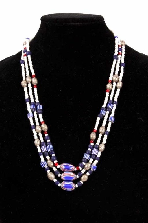 1920'S CHEVRON cain with trade silver.: This lot features 3 matching necklaces all strung on sinew. Each strand features a1920's glass Chevron trade bead. It has 18 silver trade beads and also has many other glass trading beads dating back 