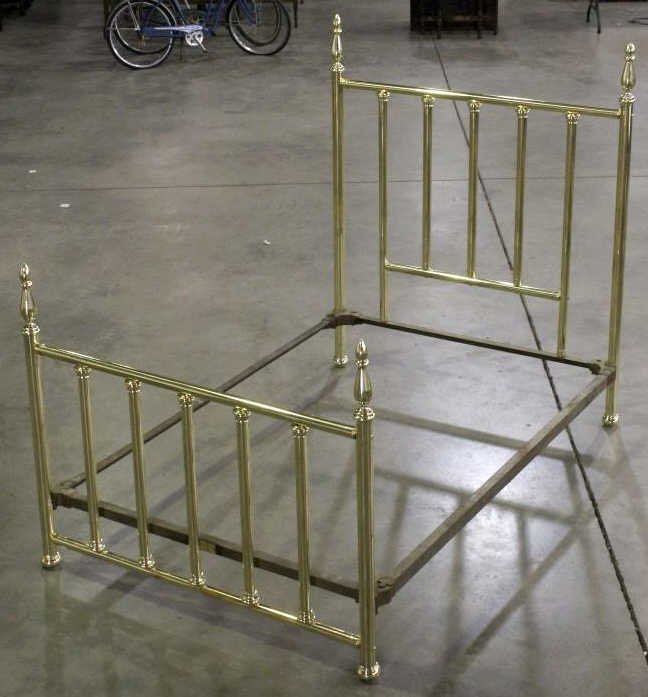 1800's Solid Polished Brass Bed: This bed is in excellent condition and has been professionally re-finished and polished. This shows four beautiful post and a cast iron rail frame. The bed measures 55" wide, 82.5" long, and 64.25" ta