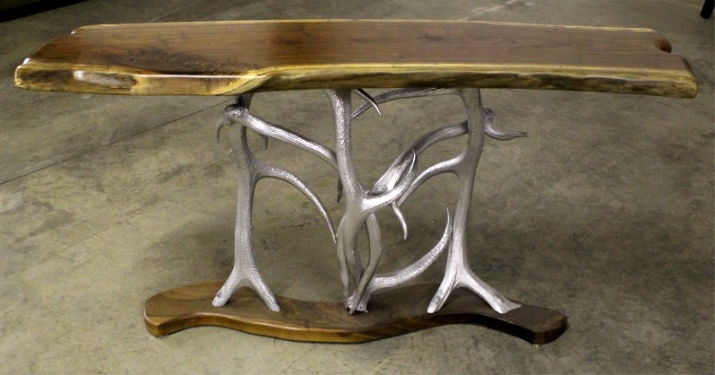 Elk Antler Sofa Table: This rustic sofa table gives a impressive modern spin showing the metal colored antlers holding the rustic wood top and base. Measures 59.5" l x 16" d x 31.5" t.